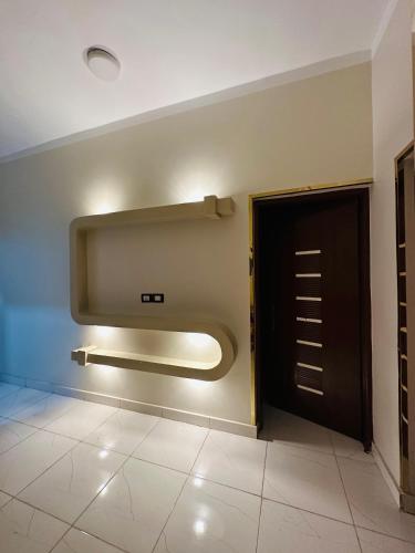 a bathroom with a large flat screen tv on the wall at Habob Nubian Guest House in Aswan