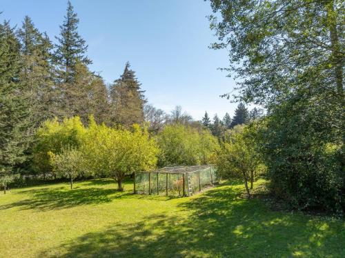 a greenhouse in the middle of a field with trees at Family Fun, Private, Close To Trails, Beaches in Olga