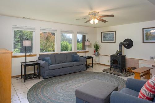 a living room with a couch and a stove at Family Fun, Private, Close To Trails, Beaches in Olga