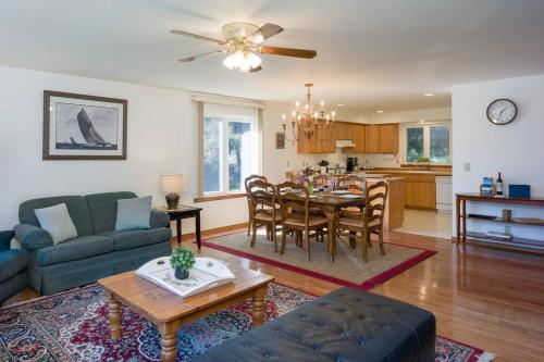 a living room and kitchen with a table and a couch at Family Fun, Private, Close To Trails, Beaches in Olga