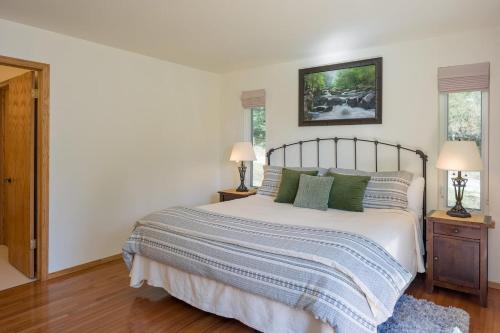 a bedroom with a large bed with green pillows at Family Fun, Private, Close To Trails, Beaches in Olga