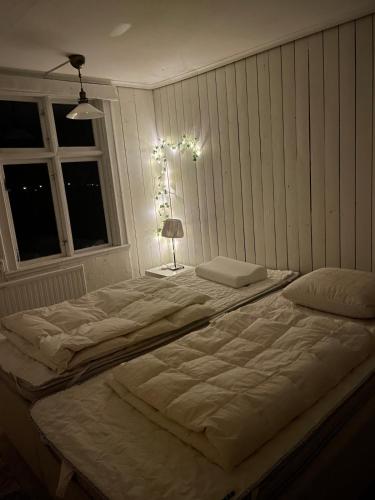 a large white bed in a room with a window at Large house in rosenfors near Borgholm for rent in Borgholm