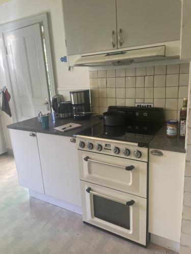 a kitchen with a stove and a counter top at Large house in rosenfors near Borgholm for rent in Borgholm