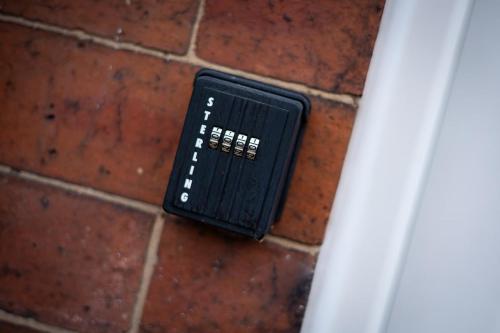 a black object sitting on a brick wall at Home Near Leeds City Centre & Elland Road in Beeston