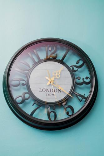 a clock with london written on it on a wall at Avek Home Stay Ngorongoro Room in Uru