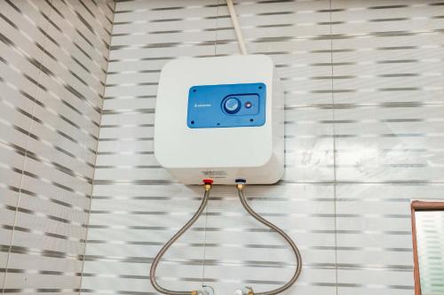 a soap dispenser on the wall of a bathroom at Avek Home Stay Ngorongoro Room in Uru