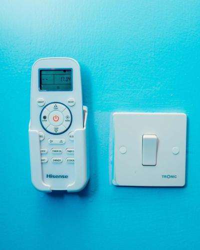 a cell phone in a holder next to a adapter at Avek Home Stay Ngorongoro Room in Uru