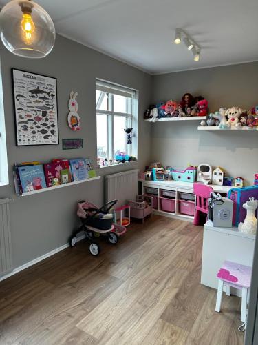 a childs play room with toys and shelves at Great Villa in Ólafsvík in Ólafsvík