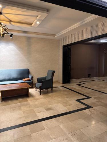 a living room with a couch and a chair at Arizona Lodge 2 in Islamabad