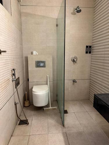 a bathroom with a toilet and a glass shower at Arizona Lodge 2 in Islamabad