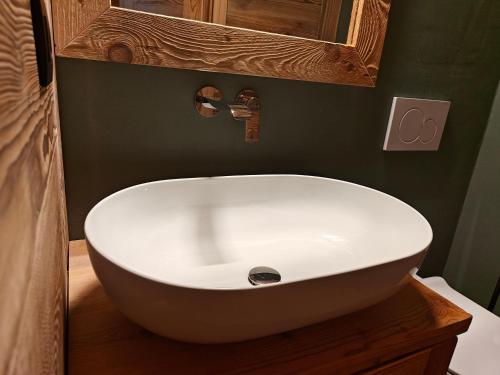 a bathroom with a white sink and a mirror at Le Grenier d'Antan - Relax Suite in Aosta