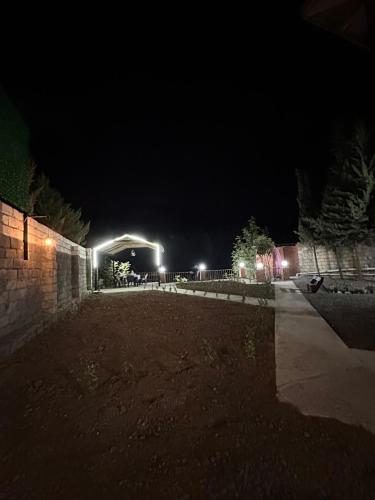 a parking lot at night with lights in the background at Ashla guest house in Lankaran
