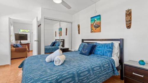 a bedroom with a bed with a stuffed animal on it at Unit facing Steps Beach and with close beach access in Rincon