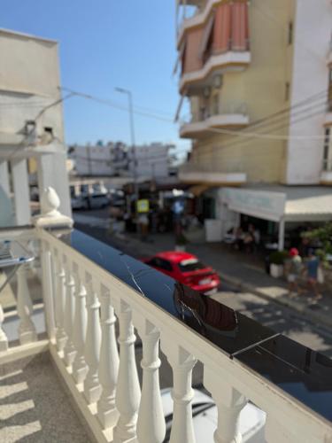 a balcony with a white railing and a street at Vironas Hotel in Himare