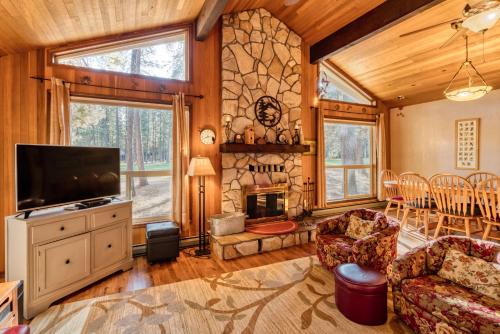a living room with a fireplace and a tv at Golf Home 010 in Black Butte Ranch