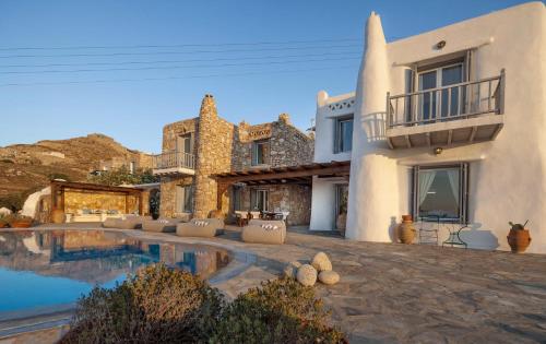 a house with a swimming pool in front of a house at The Aegean Residence Villa 6 Bedroom nearby the City in Kanalia Area by Hospirit in Mýkonos City