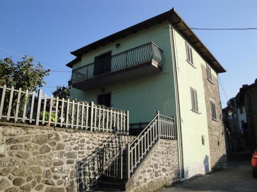 a building with a staircase and a balcony at Casa con giardino da Toni in San Romano in Garfagnana