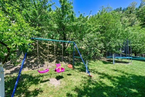 a playground with a swing set in a yard at Holiday home Pavic with jacuzzi and sauna in Krapina