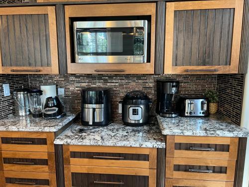a kitchen counter with a coffee maker and a microwave at A Gorgeous Mansion for Jasper Vacation in Hinton