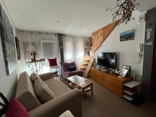 a living room with a couch and a tv at Alojamiento Evelyne Cal Paleta Noves de Segre in Novés de Segre