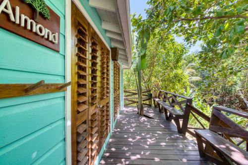 a wooden walkway outside of a blue building with benches at Camp Bay Lodge in Camp Bay