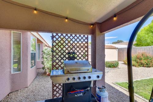 a barbecue grill in a backyard with a fence at Kingman Family Home Yard, Grill and Room to Relax! in Kingman