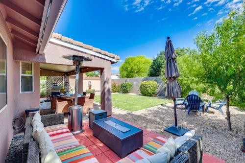a patio with a grill and an umbrella at Kingman Family Home Yard, Grill and Room to Relax! in Kingman