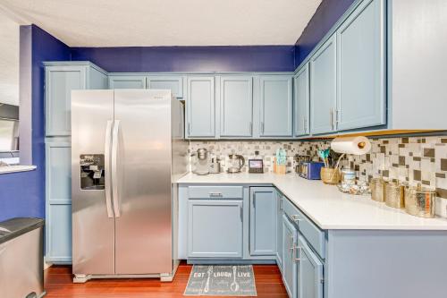 a kitchen with blue cabinets and a stainless steel refrigerator at A Time to Remember Home in Tobyhanna with Pool! in Tobyhanna