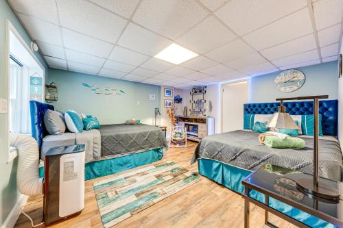 two beds in a room with blue walls at A Time to Remember Home in Tobyhanna with Pool! in Tobyhanna