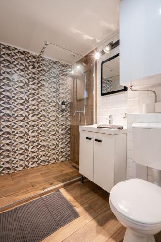 a bathroom with a toilet and a shower and a sink at Funhouse Dob in Budapest