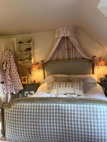 a bedroom with a bed with a canopy at Meesden Hall in Meesden
