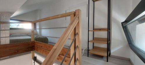 a room with a bunk bed and a staircase at APPARTEMENT 4 PERSONNES 100 metres du Lac jardin privé in Doussard