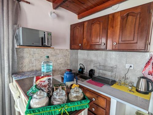 a kitchen with wooden cabinets and a counter top at Dpto Lolo 1 - A 200 metros de la Terminal - con Cochera in Formosa