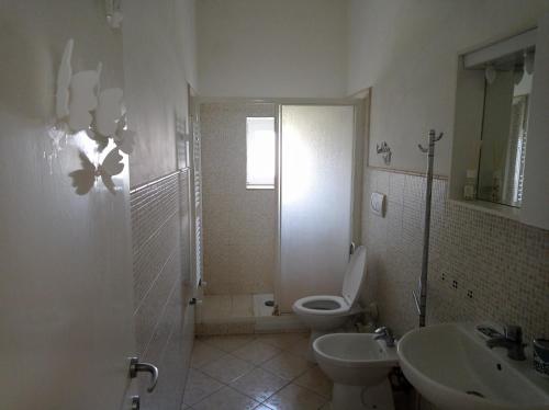a bathroom with a toilet and a sink and a shower at CasinaAlice Montenero in Livorno