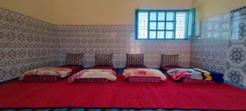 Voodi või voodid majutusasutuse Chambre partagée Hostel DAIFLAH toas