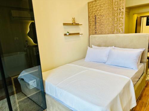 a small bedroom with a bed and a bath tub at Golden Era stylish studio i903 TenTon Zamalek in Cairo
