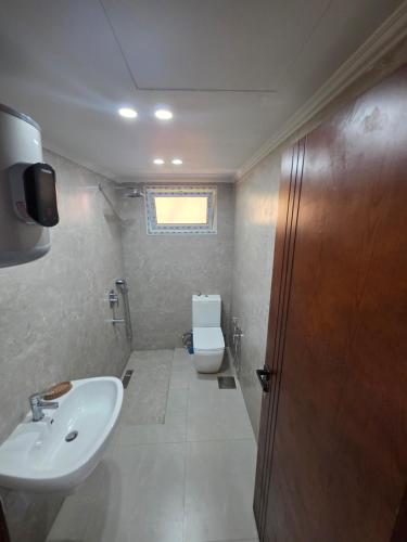 a bathroom with a sink and a toilet at PORTO MATRUH-modern home in Marsa Matruh