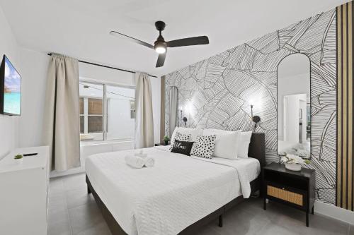 a bedroom with a bed with a black and white patterned wall at Harding Apartments by Andes STR in Miami Beach