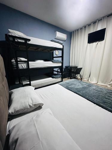 a bedroom with two bunk beds and a window at On Park Hotel e Traslado in Guarulhos