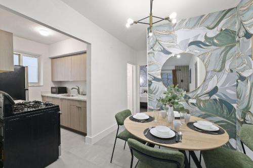 a kitchen and dining room with a table and chairs at Harding Apartments by Andes STR in Miami Beach