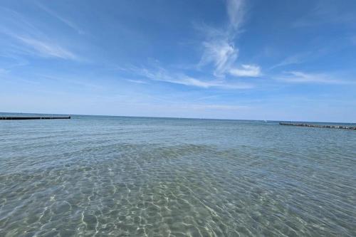 a large body of water with a blue sky at Appartements Post Hiddensee in Vitte in Vitte