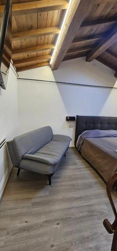 a bedroom with a bed and a couch at HOUSE Sant'Angelo in Acquapendente