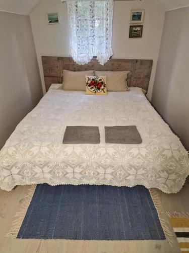 a bedroom with a bed with two mats on it at An authentic granary in Bilioniai