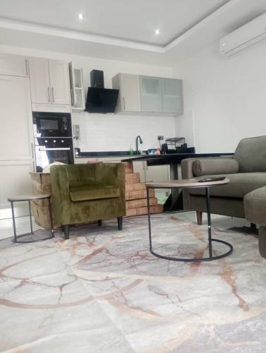 a living room with a couch and a table at Elite Arlington Court Apartment - East Legon in Accra