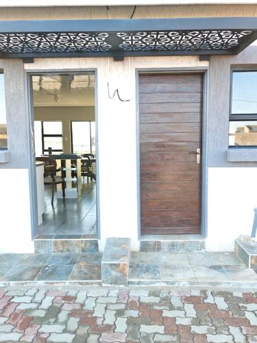 a wooden garage door on the side of a house at The Residence Apartments in Maseru