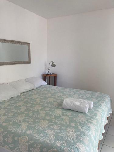 a bedroom with a bed with a pillow on it at Hotel Casa Del Angel in Chetumal