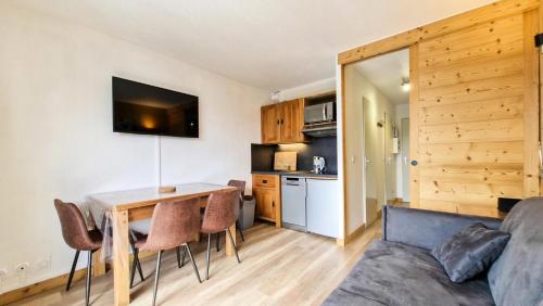 un soggiorno con tavolo e sedie e una cucina di Résidence Iris - Studio entièrement rénové avec cabine · Centre station · Balcon MAE-4504 a Magland