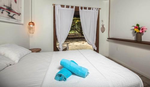 a white bed with a blue object on top of it at Camp Bay Lodge in Camp Bay
