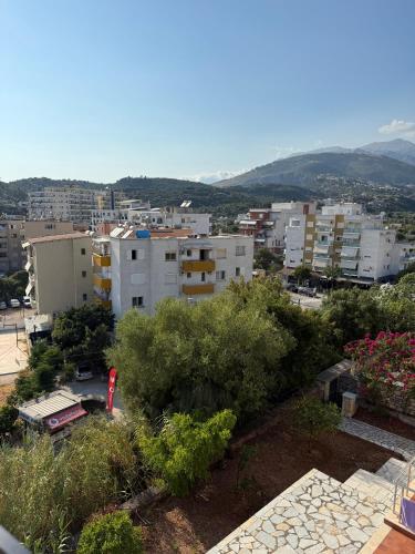 a view of a city with buildings and trees at Vironas Hotel in Himare