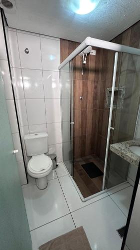 a small bathroom with a toilet and a shower at Hotel Praça Orione in São Paulo